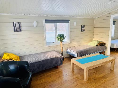 a living room with a couch and a table at Hellisholar Cottages in Hvolsvöllur