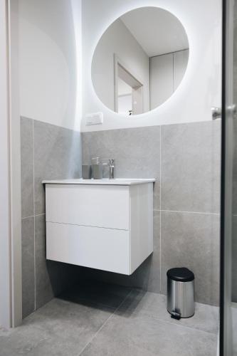 a bathroom with a white sink and a mirror at Lubelski Kadr in Lublin