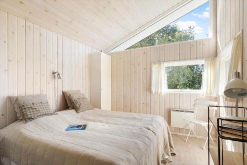 a bedroom with a bed in a room with a window at 20225-Samso-Rosenvej-9 in Tanderup