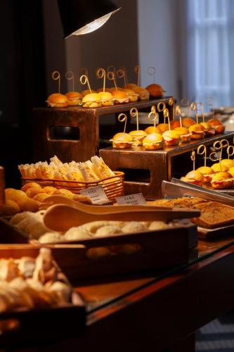 a buffet of pastries and breads on display at Fera Palace Hotel in Salvador