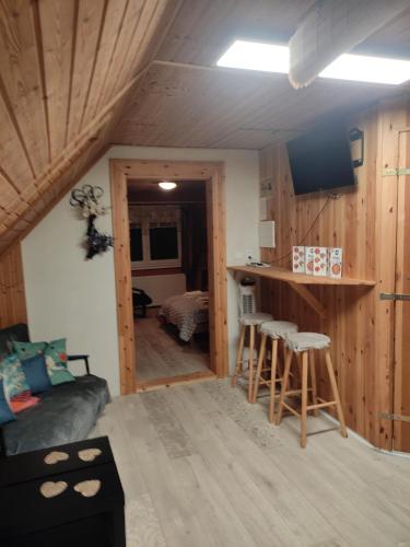 a living room with a couch and a bar in a room at Apartmán Roztoky u Křivoklátu in Roztoky