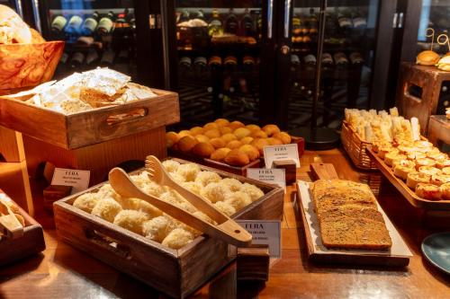 a display of different types of bread and pastries at Fera Palace Hotel in Salvador