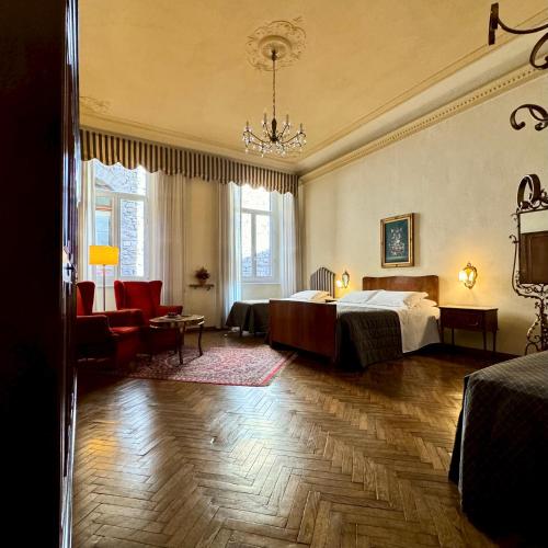 a bedroom with a bed and a couch and a chair at Hotel Cestelli in Florence