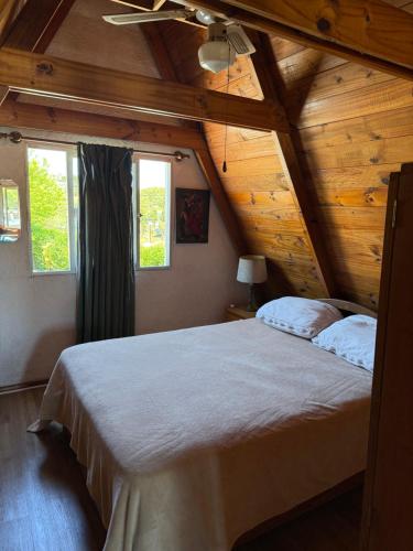 a bedroom with a large bed in a wooden ceiling at Mar 11 -ALOHA in Parque del Plata