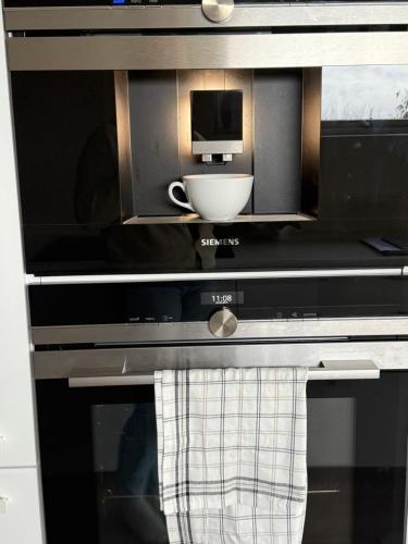 a microwave oven with a bowl inside of it at Panoramic sea view apartment on Tjøme in Tjøme