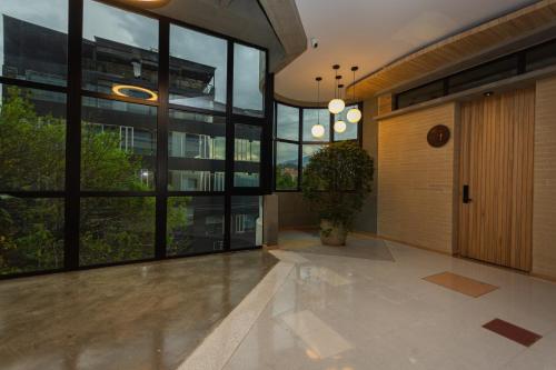 an empty lobby with a door and windows at Hotel Boutique Obelisco in Medellín