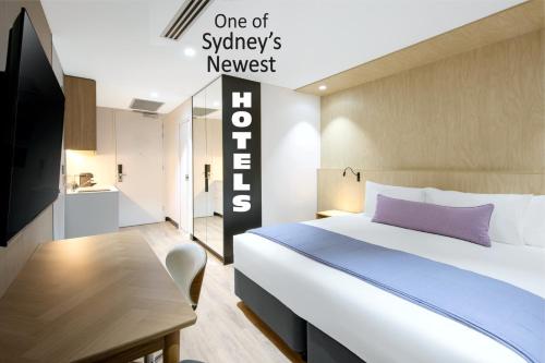 a hotel room with a bed and a tv at Haberfield Hotel in Sydney