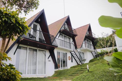 a large white house with black roof at TRIP MOUNT in Vagamon