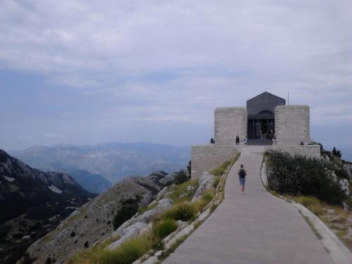 a person walking down a path on a mountain at Apartments Mirković in Cetinje