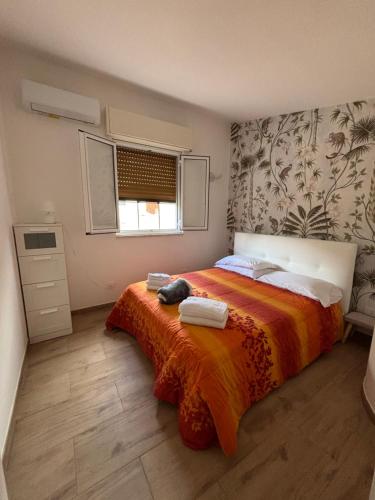 a bedroom with a bed with towels on it at White Moon in Fontane Bianche
