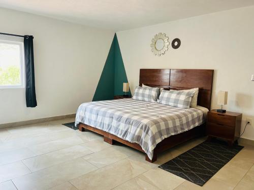 a bedroom with a bed and a clock on the wall at Pedernal Hotel in San Miguel de Allende