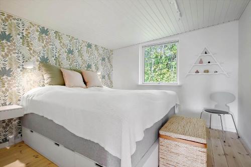 a bedroom with a large white bed with a window at N337-Karrebaeksminde-Strandrylevej-11 in Enø By