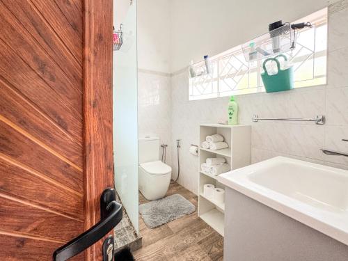 a bathroom with a sink and a toilet at Beachfront Villa near Mont Choisy Beach in Grand Baie