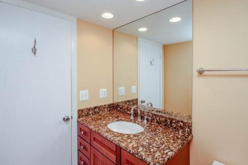 ein Badezimmer mit Waschbecken und großem Spiegel in der Unterkunft Sea Colony - 303N Edgewater House Rd in Sea Colony