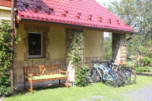 a group of bikes parked next to a house with a bench at Dom na Klonowym Wzgórzu in Stronie Śląskie