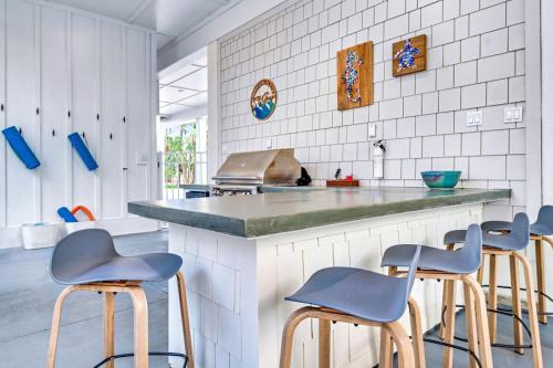 a kitchen with blue stools at a counter at Endless Summer St George 4Bed 3 5 Bath with POOL in St. George Island