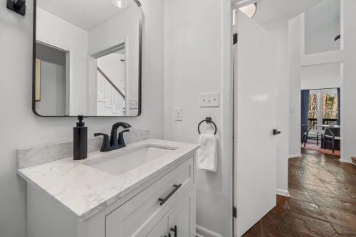 a white bathroom with a sink and a mirror at Pet Friendly, Mini Golf, Game Room, Hot Tub in McGaheysville