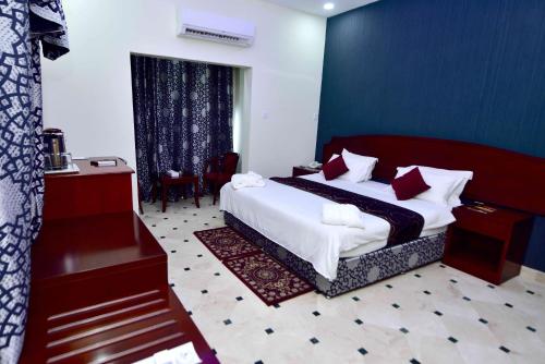 a hotel room with a bed and a piano at Al Bahjah Hotel in Seeb