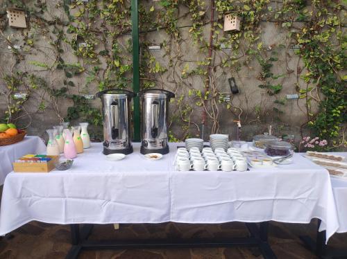 a white table with food and drinks on it at Hotel Terra by Refugio Ecológico in Arequipa