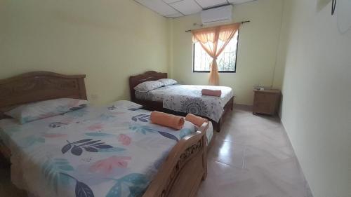 une chambre avec deux lits et une fenêtre dans l'établissement Bonito Apartamento en Mompox, à Santa Cruz de Mompox