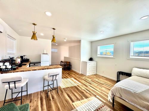 a kitchen and living room with a bed and a counter at Glacier Alpine Escape in East Glacier Park