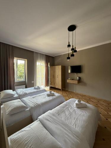 a room with four beds and a window at Nest Stay in Tbilisi City