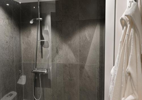 a bathroom with a shower with a glass door at Togton Premium Suite Växjö in Växjö