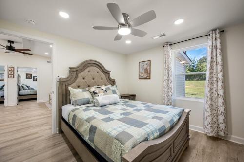 a bedroom with a bed and a ceiling fan at The Pine House in Davidson