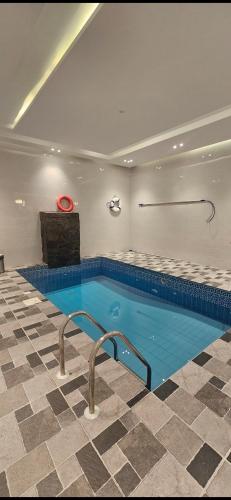 a large swimming pool with a red frisbee in it at دهم الرمك in Khamis Mushayt