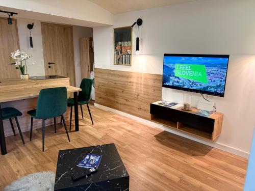 a living room with a large flat screen tv on a wall at URBAN BASE CELJE Apartment with FREE Parking & Terrace in Celje