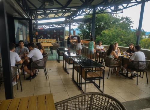 a group of people sitting at tables in a restaurant at Viajero San José Hostel in San José