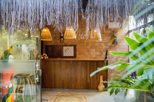 a room with a counter with pendant lights at Naim Milagres in São Miguel dos Milagres