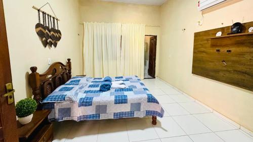 une chambre avec un lit avec une couverture bleue et blanche dans l'établissement São Luiz Experiência Única: Casa na Areia da Praia do Meio, à São José de Ribamar