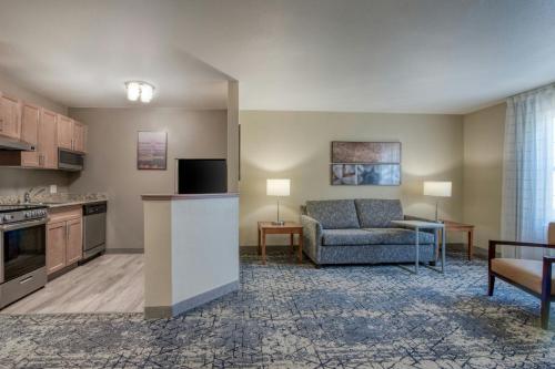a kitchen and living room with a couch and a table at TownePlace Suites Raleigh Cary/Weston Parkway in Cary
