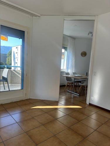 a living room with a view of a table and chairs at BelliCastelApartment in Bellinzona