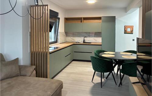 KaštelinaにあるBeautiful Home In Virのキッチン(テーブル、緑の椅子付)