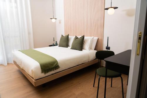 a bedroom with a bed and a table and a desk at Casa Teresinella Pompei in Pompei