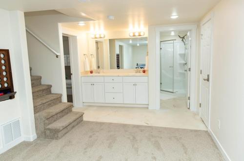 a white bathroom with a sink and a mirror at The Suite Potato in Twin Falls