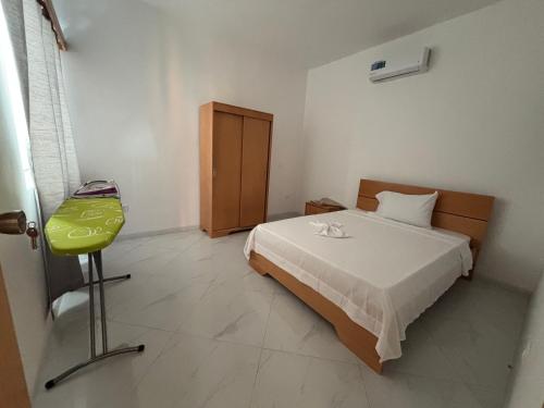 a bedroom with a bed and a chair in it at GP Apartamentos in São Filipe