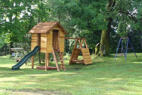 a playground with a slide and a play house at Dom na Klonowym Wzgórzu in Stronie Śląskie