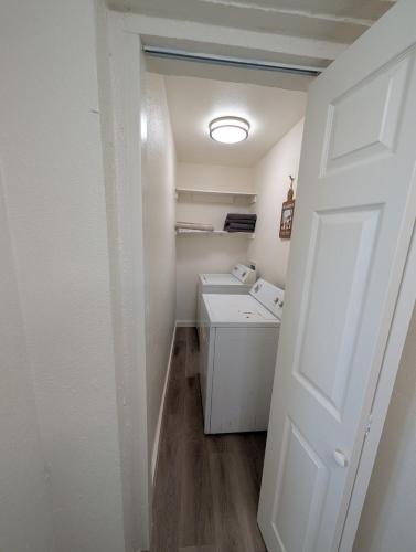 a small white laundry room with a washer and dryer at Casa Valencia in Tucson