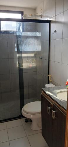 a bathroom with a toilet and a glass shower at Apartamento 2 quartos COP 30 in Belém