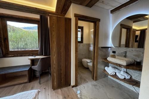 a bathroom with a sink and a toilet and a window at La Locanda in Livigno
