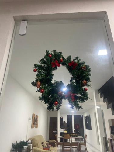 a christmas wreath is hanging in a living room at Casa para o Natal perto do palco centro, 3 quarto in Garanhuns