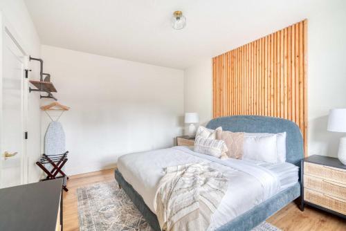 a bedroom with a large bed with a blue headboard at Stay Portland - Perfect Brooklyn 1 Bedroom in Portland