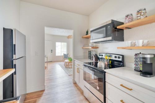 a kitchen with white cabinets and a black stove top oven at Stay Portland - Perfect Brooklyn 1 Bedroom in Portland