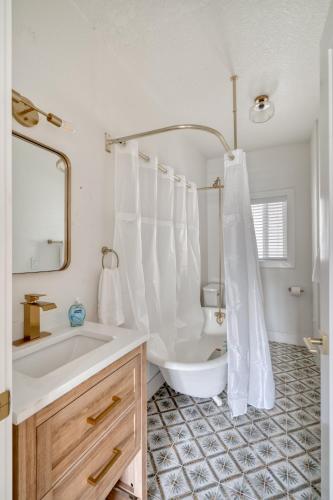 a white bathroom with a tub and a sink at Stay Portland - Perfect Brooklyn 1 Bedroom in Portland