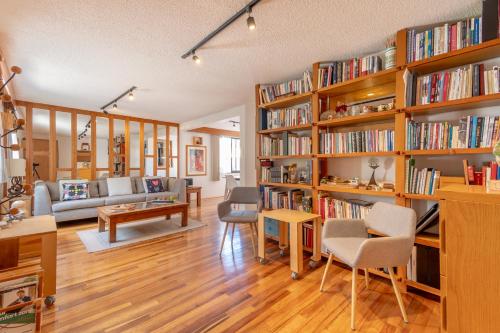a living room filled with book shelves filled with books at Elegant and comfortable apartment near Coyoacán in Mexico City