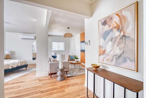 a living room with a large painting on the wall at Stay Portland - Spacious Studio in Brooklyn in Portland