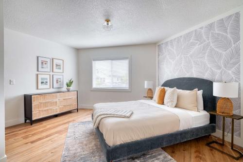 a bedroom with a large bed and a dresser at Stay Portland - Spacious Studio in Brooklyn in Portland